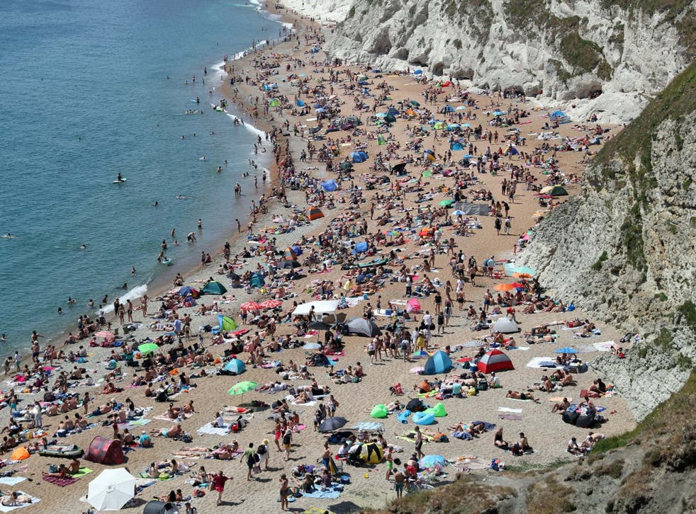<p> The beach at Durdle Door was crowded  over the summer</p>
