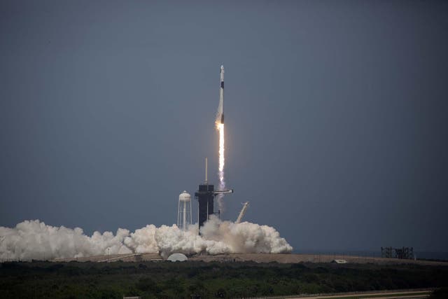 The SpaceX Falcon 9 rocket launches into space with NASA astronauts Bob Behnken (R) and Doug Hurley aboard the rocket from the Kennedy Space Center on May 30, 2020 in Cape Canaveral, Florida