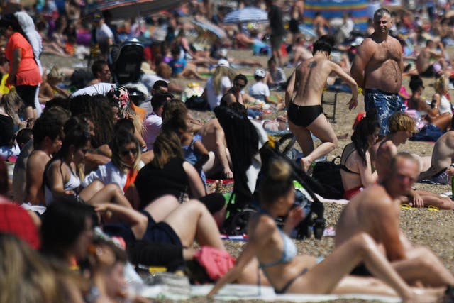 People enjoy the sunshine on the beach at Southend-on-Sea in Essex over the weekend