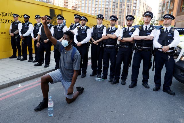 A protester takes the knee near the US embassy in London, during demonstrations against the death in Minneapolis police custody of African American George Floyd