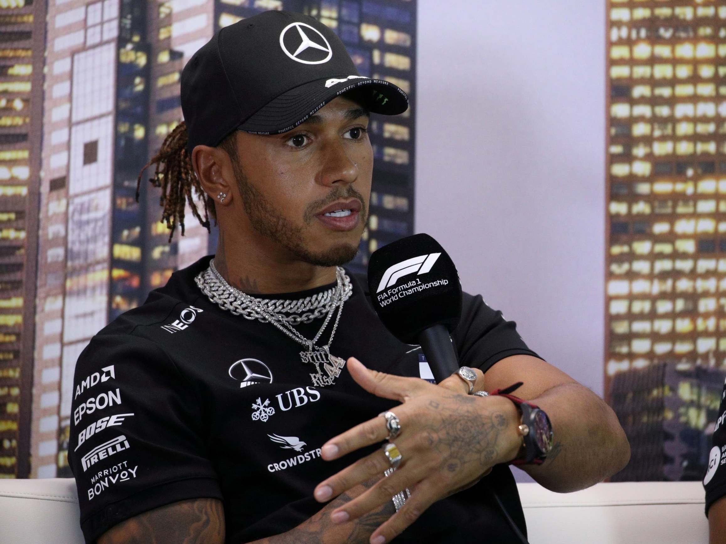 God is love” tattoo on Lewis Hamilton's left side
