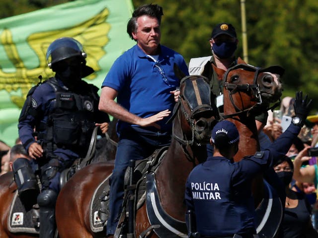 Jair Bolsonaro rides a horse during a demonstration by his supporters in Brasilia, 31 May