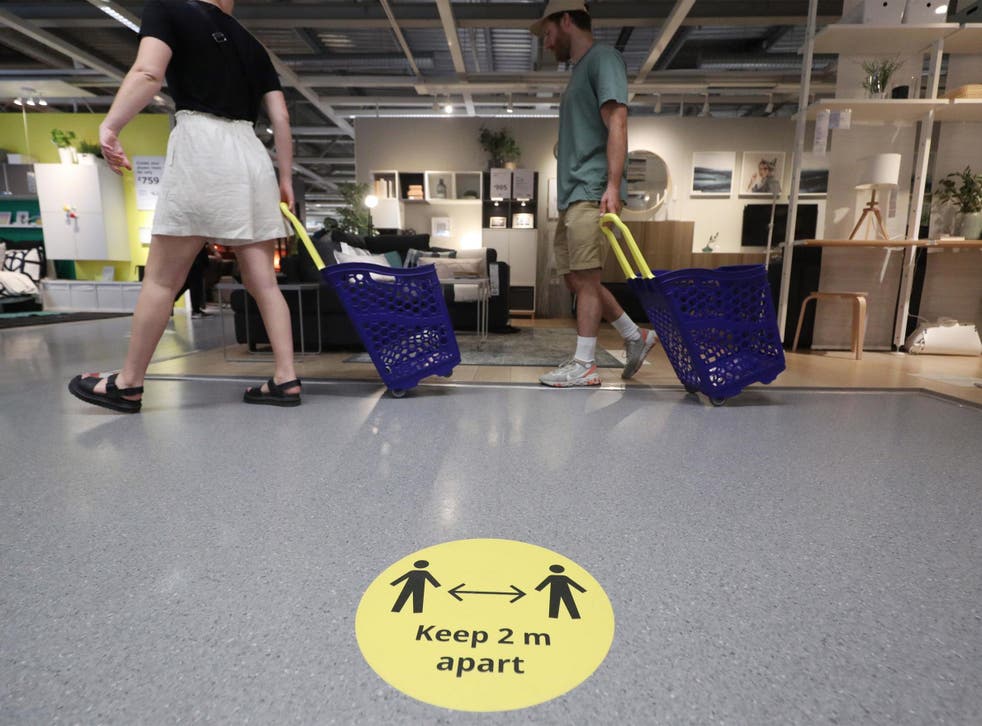 Customers observe social distancing inside the IKEA Tottenham store in Edmonton, north London, as it reopens to the public