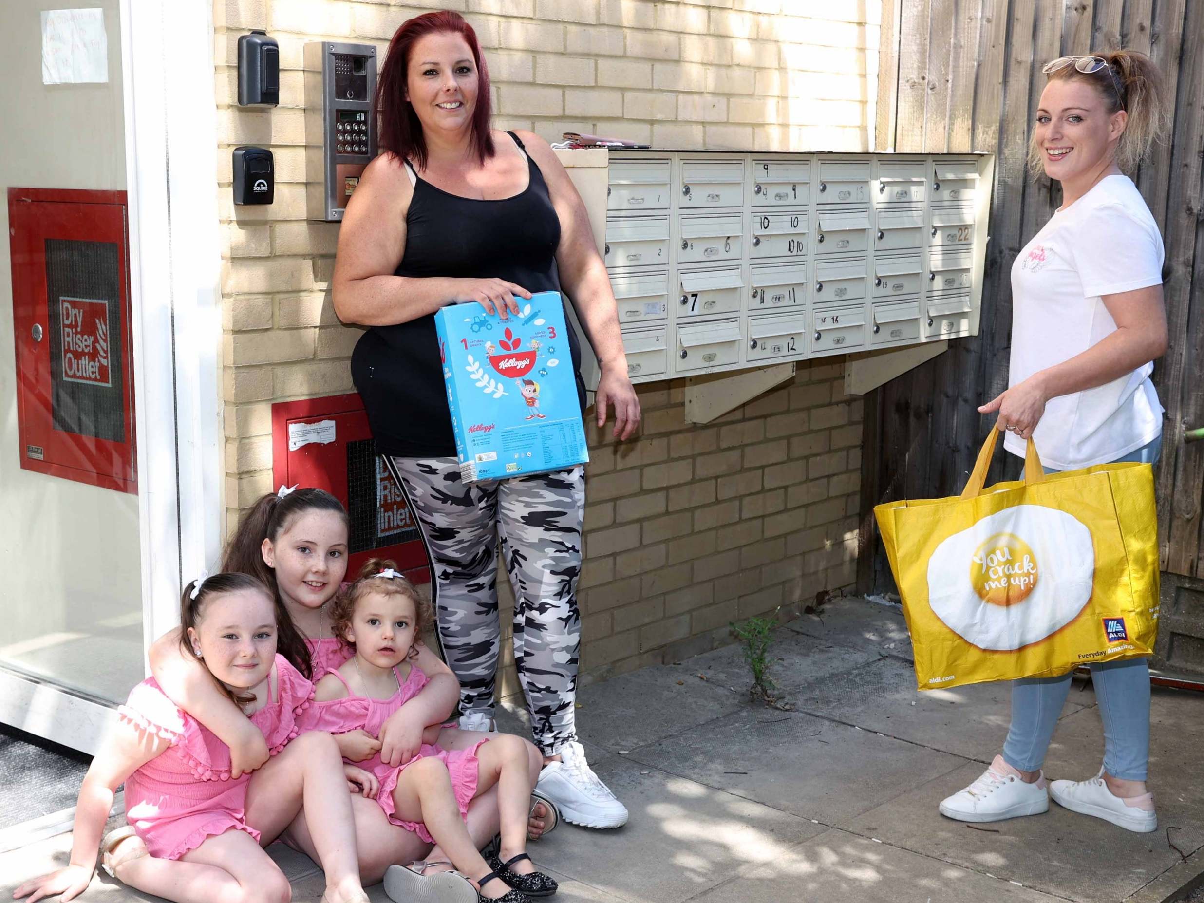 Becca Archer with her three daughters, given food donation by volunteer Katie-Louise Barber