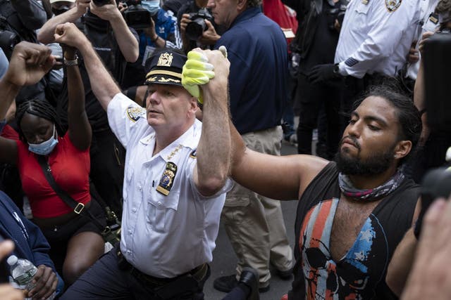 NYC's highest-ranking uniformed member takes a knee hugs George Floyd protester