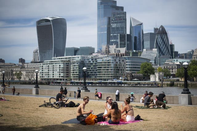 People enjoy the sun at Potters Field, London, on 2 June, 2020.