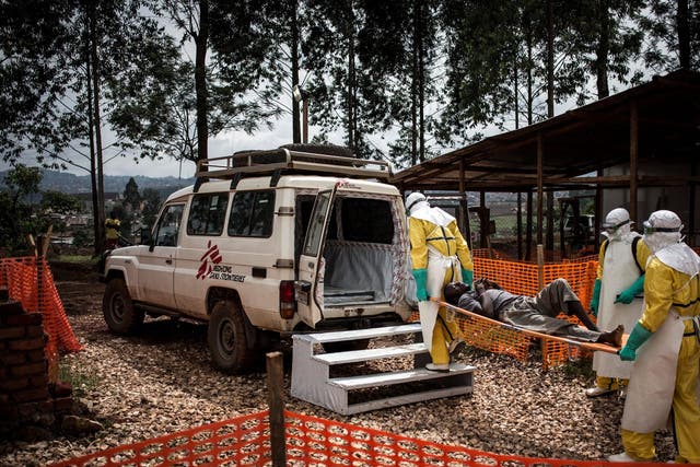Health workers move a patient in Butembo to a hospital after he was cleared of having Ebola