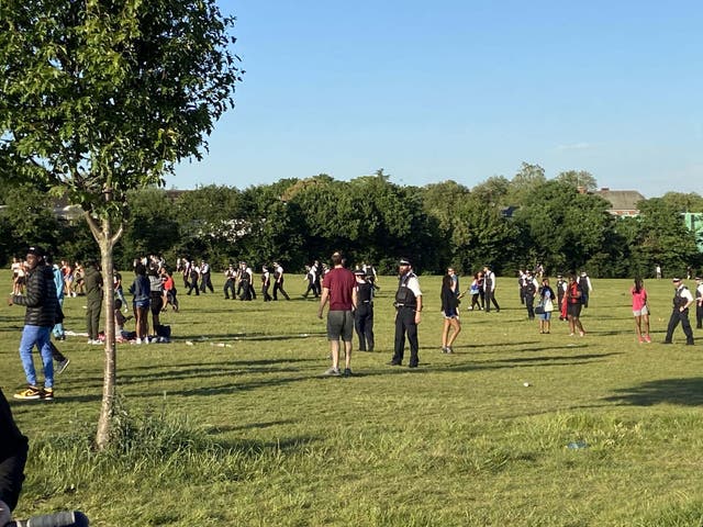 Police officers breaking up a large brawl on Hampstead Heath in north London on Tuesday evening