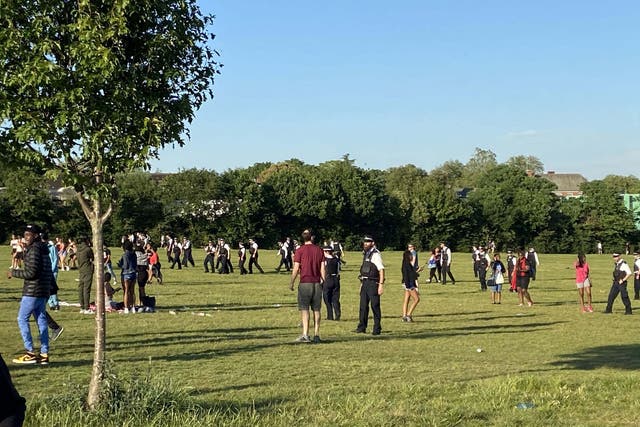 Police officers breaking up a large brawl on Hampstead Heath in north London on Tuesday evening