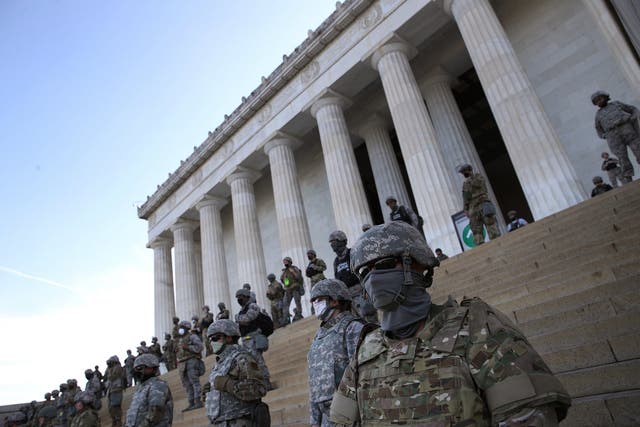 Members of the DC National Guard assemble on the steps of the Lincoln Memorial as protesters demonstrate peacefully against police brutality