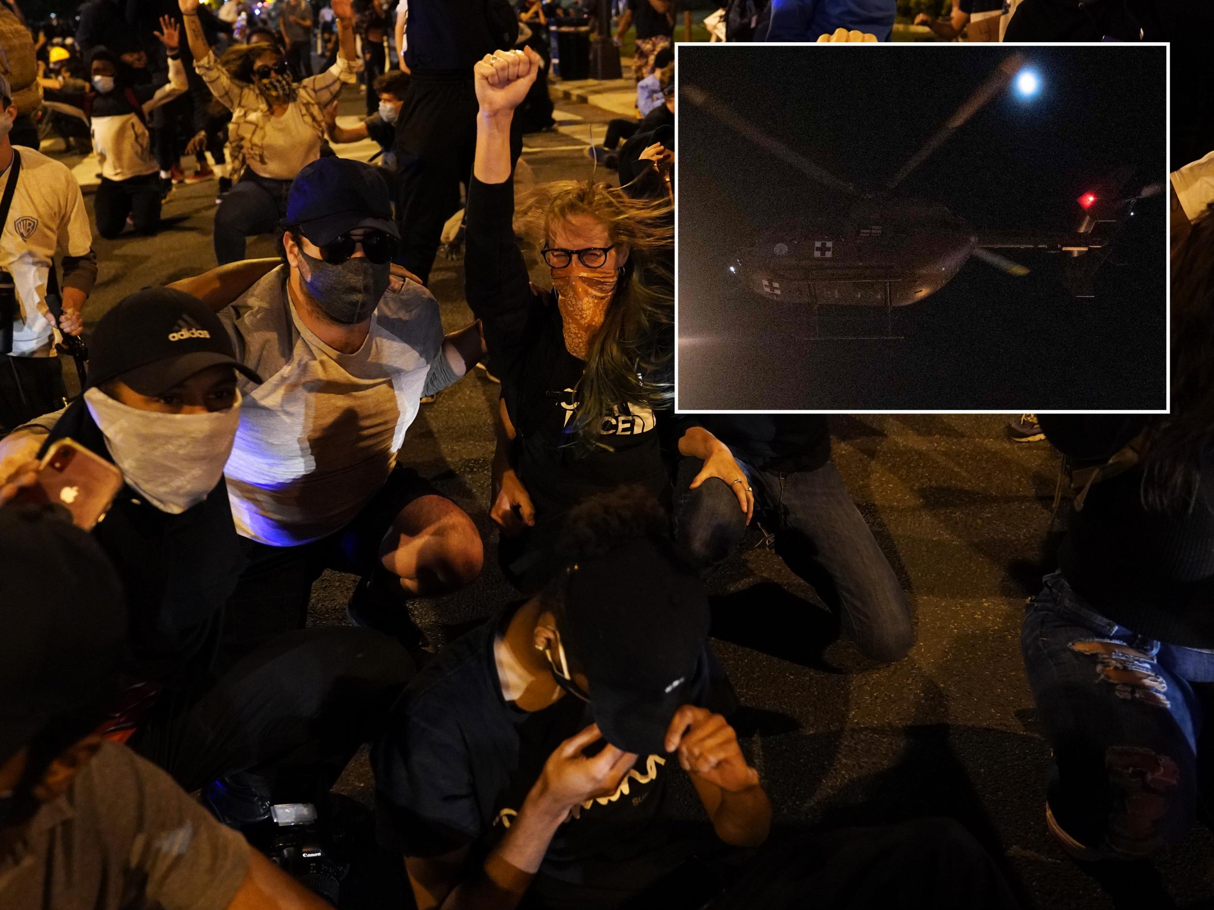 Protesters in DC take a knee as a helicopter circles above. Inset: Red cross helicopter used to dispers protesters