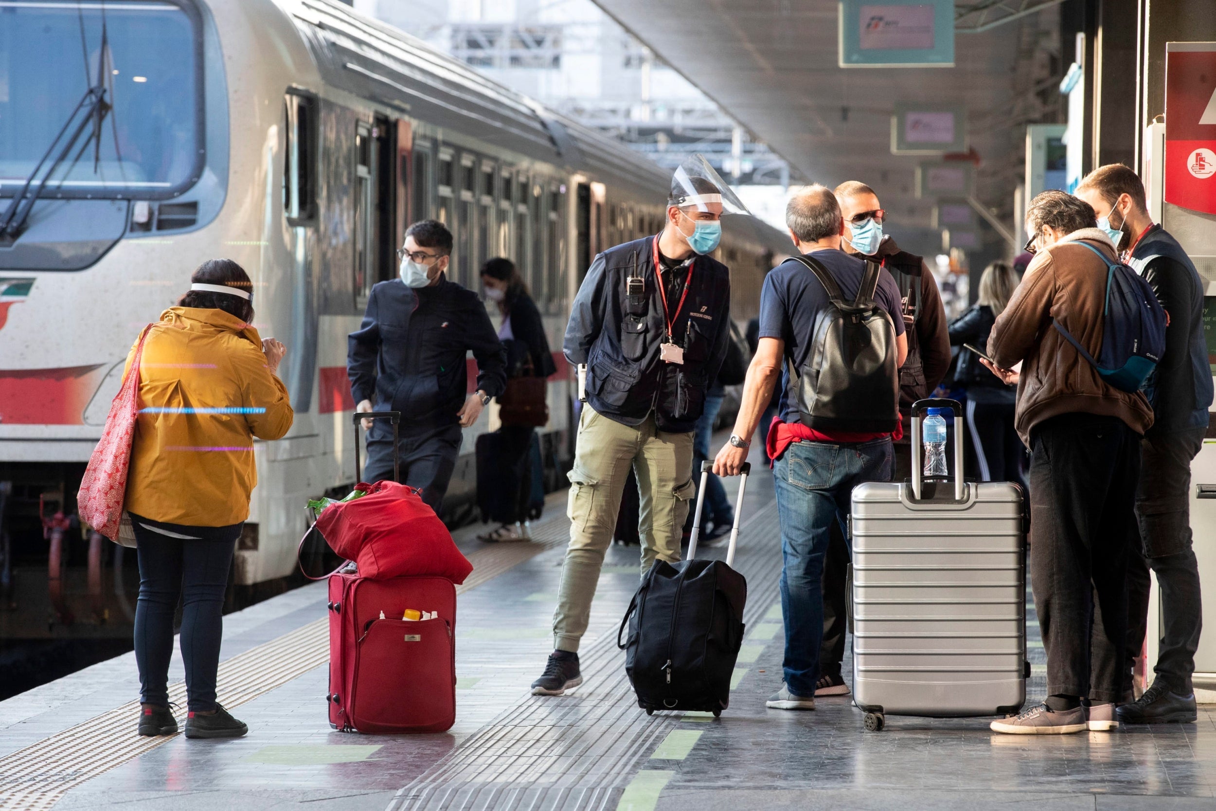 Passengers arrive at the Termini station to catch a train