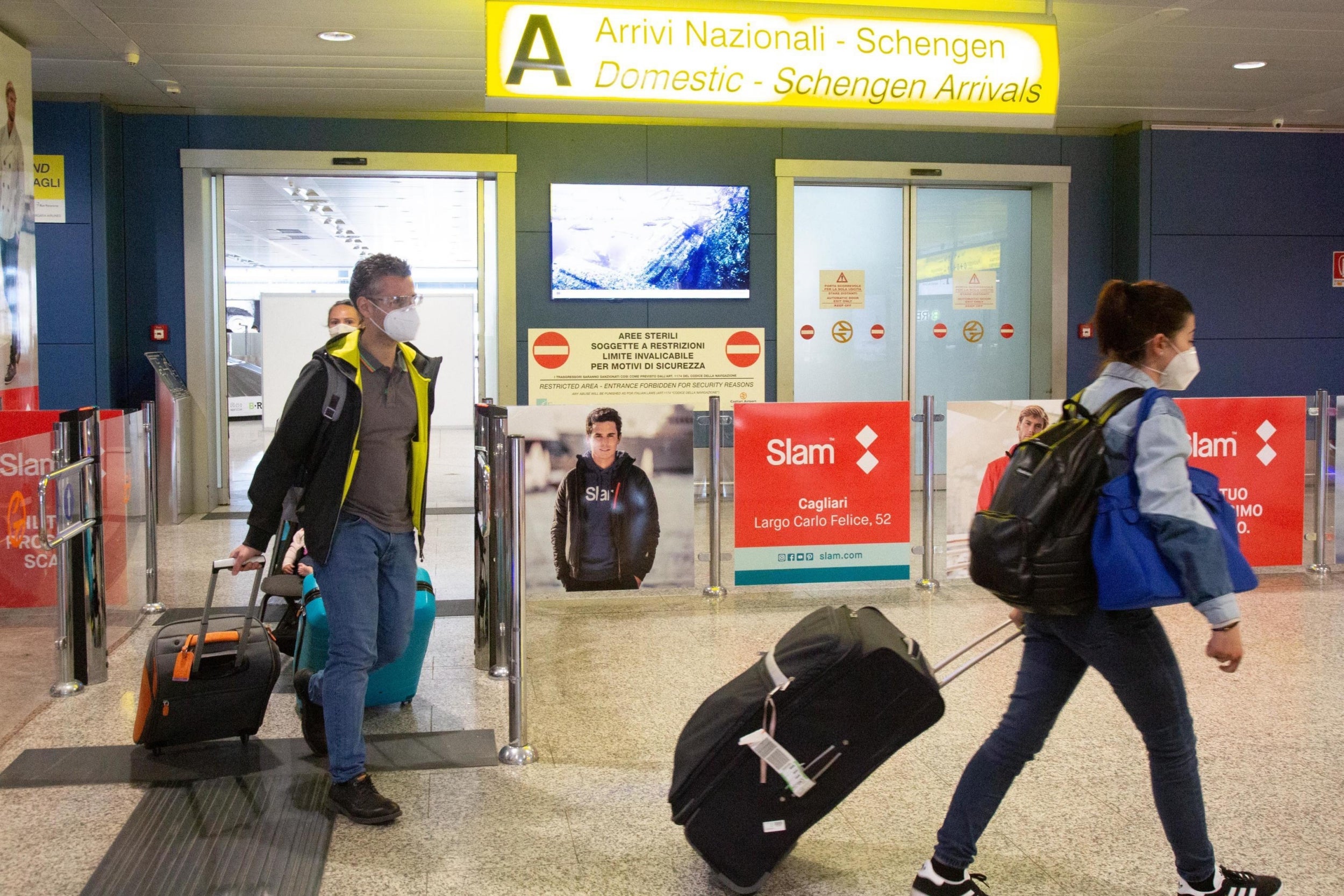 Passengers arrive at Cagliari-Elmas airport, in Cagliari, Italy,