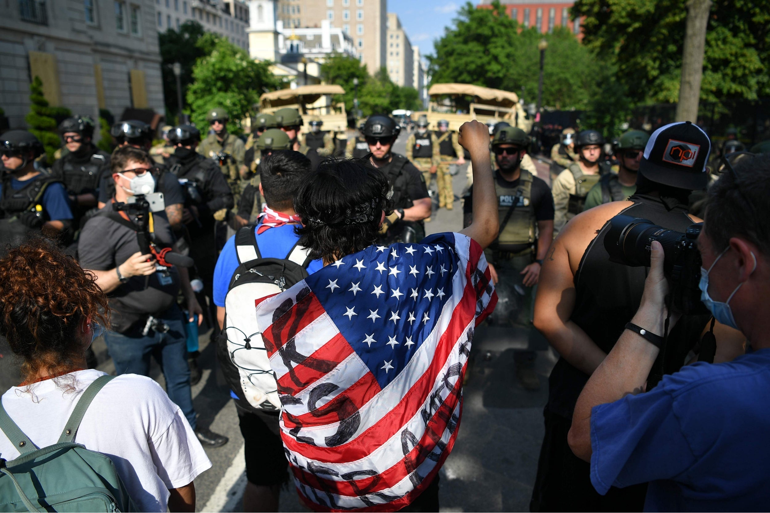 Demonstrators face police and security forces on H St near the White House, during protests over the death of George Floyd