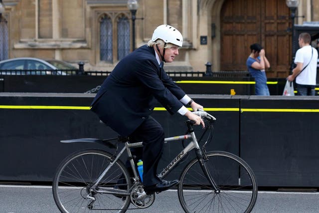 Boris Johnson cycles past the Houses of Parliament in 2013 during his second term as mayor of London