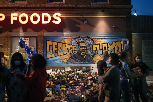 People visit a memorial at the site where George Floyd was killed in Minneapolis, Minnesota