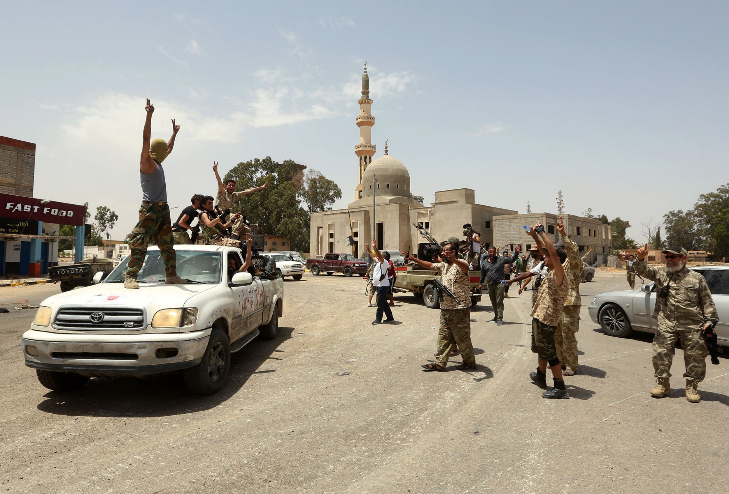 GNA fighters celebrate in the Qasr bin Ghashir district south of Tripoli