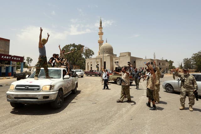 GNA fighters celebrate in the Qasr bin Ghashir district south of Tripoli