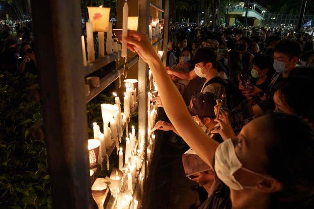 People light candles as they attend a vigil in Victoria Park in Hong Kong on June 4, 2020