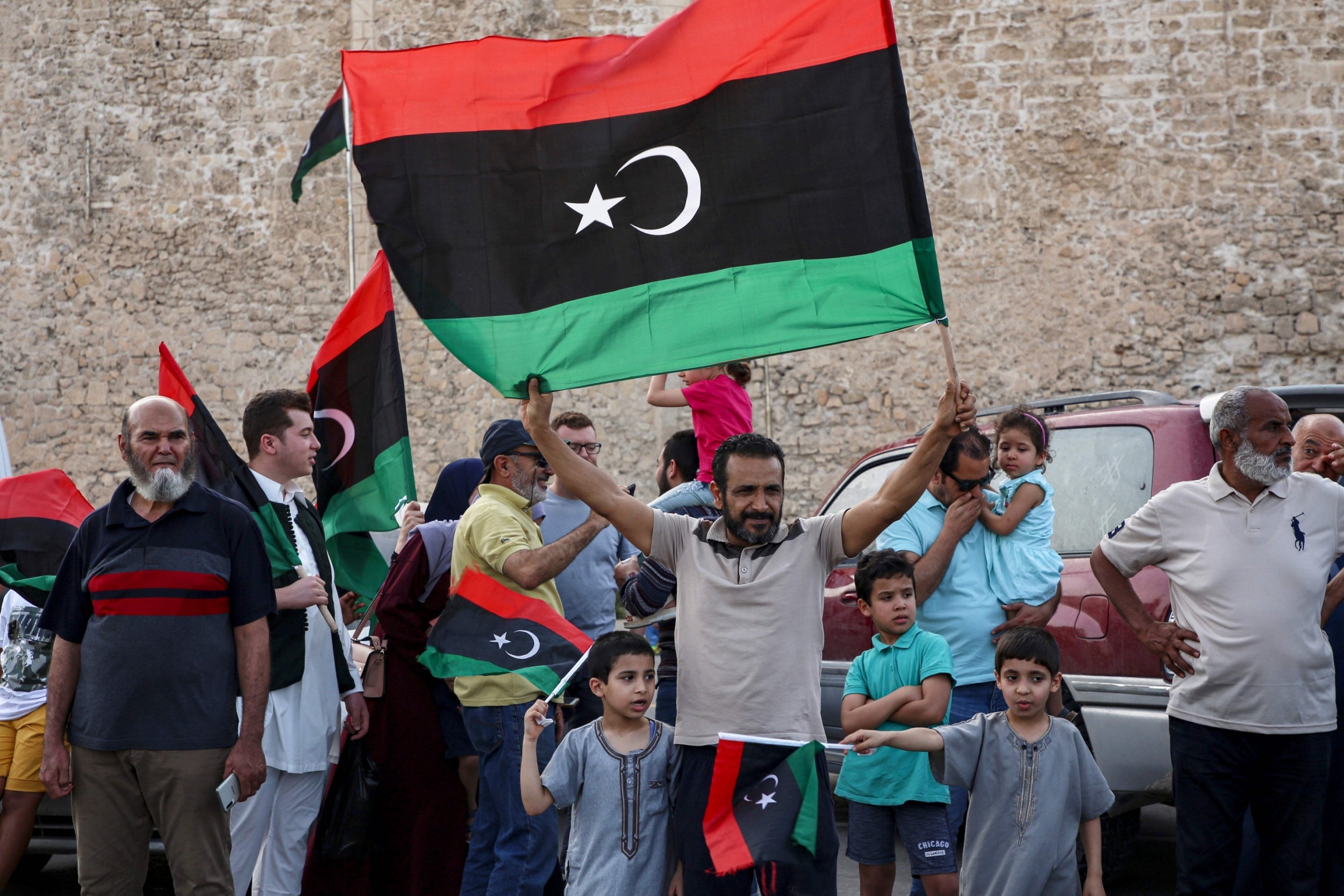 A man waves a Libyan flag in Tripoli in celebration of GNA victories this week