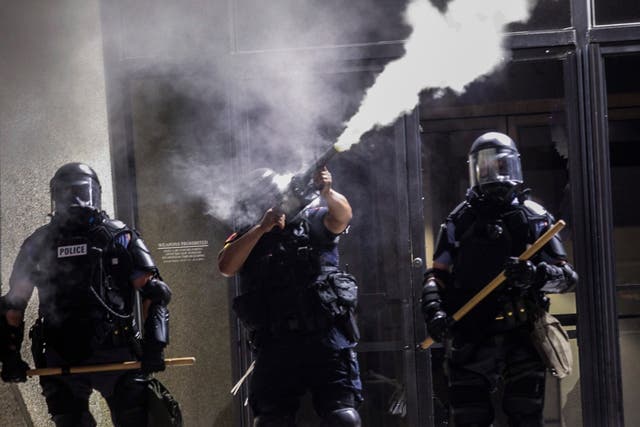 Police in riot gear fire tear gas at protesters in Raleigh, NC