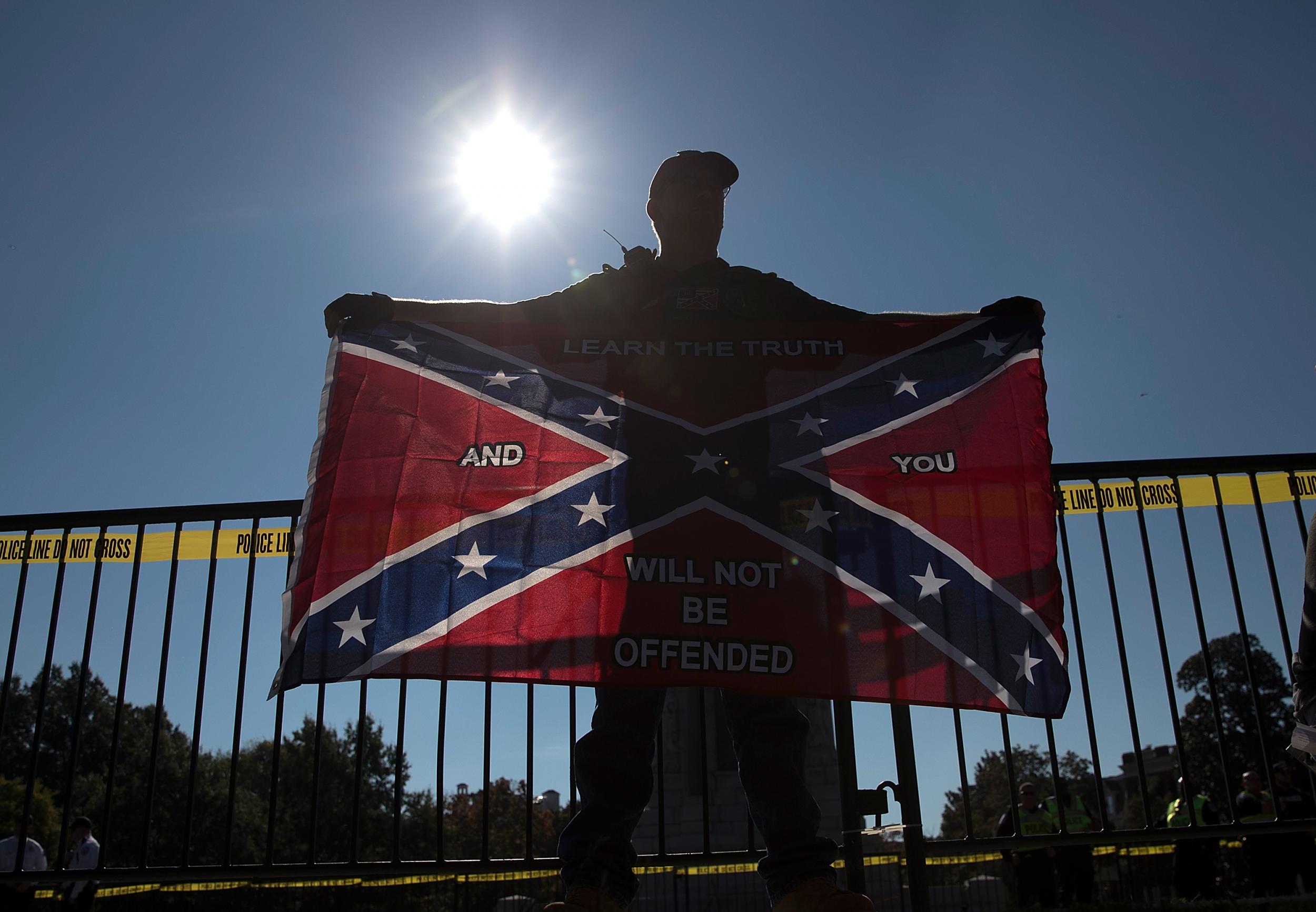 A man holds a Confederate flag during a 2017 protest in Virginia.