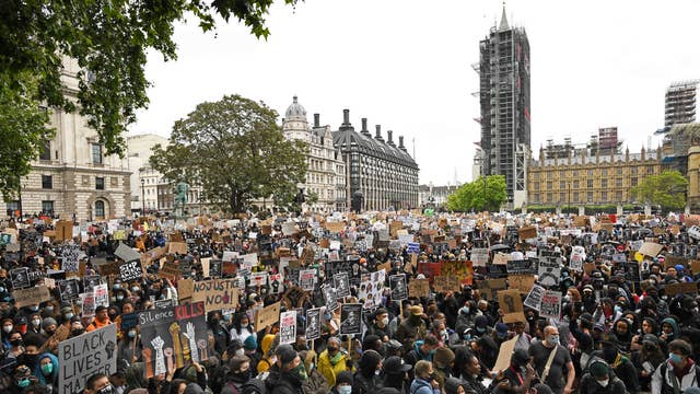 People take part in a Black Lives Matter protest rally in Parliament Square, London, in memory of George Floyd who was killed on May 25 while in police custody in the US city of Minneapolis