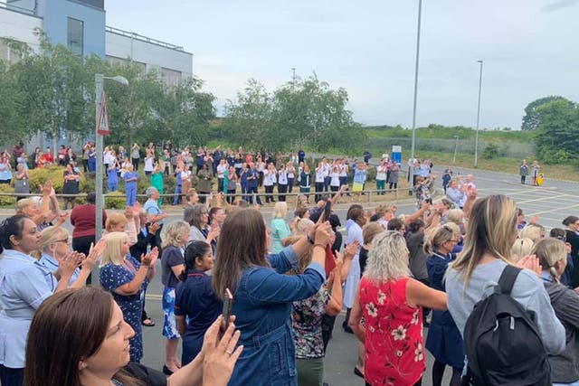 NHS workers applaud Colin Wilkinson outside Basildon Hospital in Essex.
