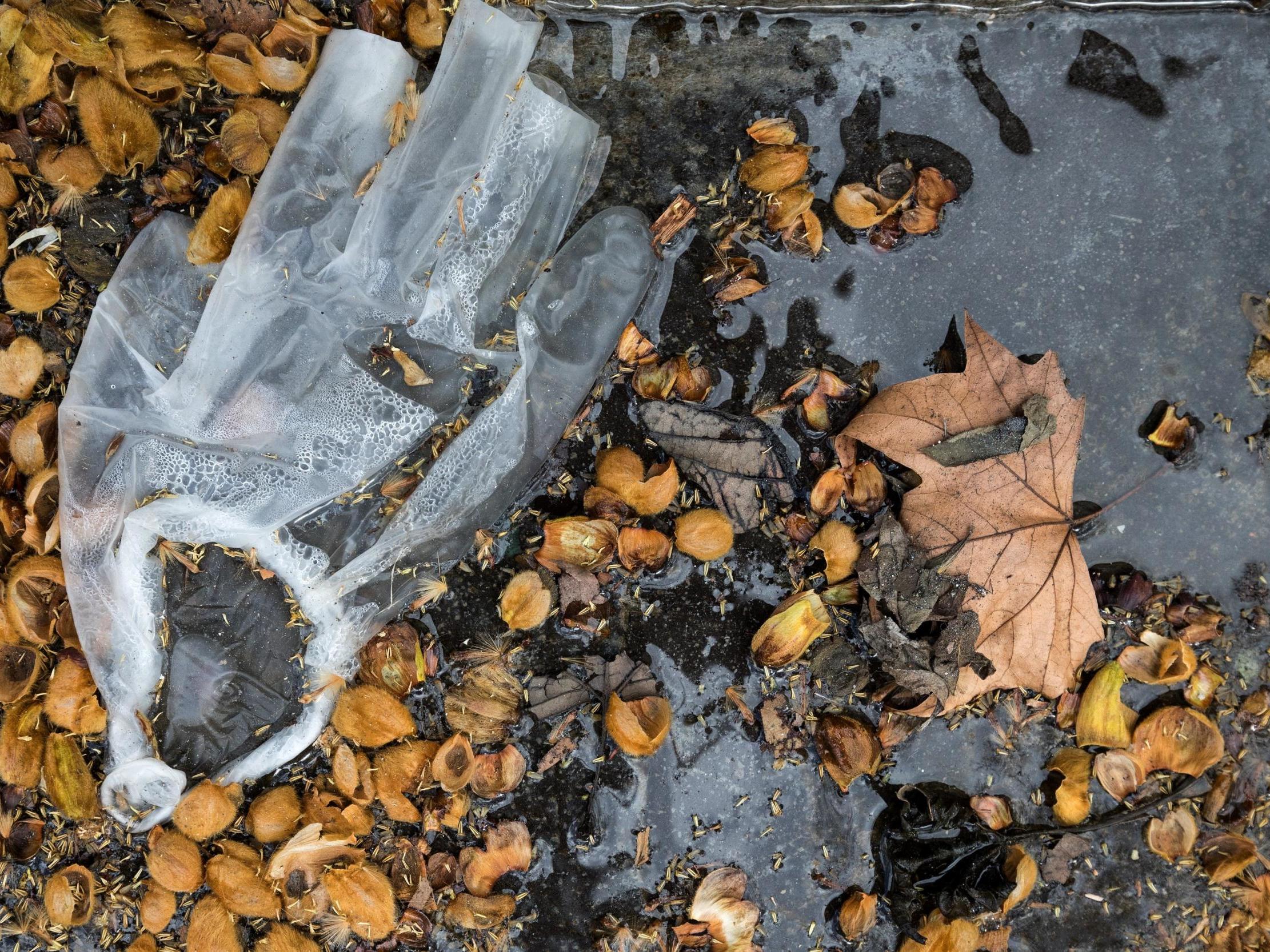 A latex plastic glove litters the street in Paris towards the start of its national lockdown over coronavirus