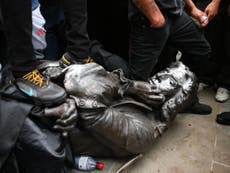 Protesters pull down statue of UK slave trader and throw it into river