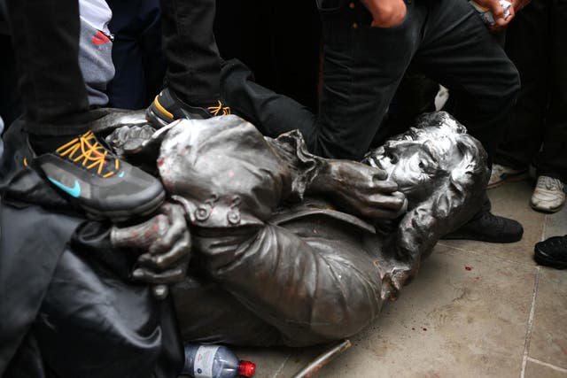 Protesters pull down a statue of Edward Colston during a Black Lives Matter protest rally in College Green, Bristol.