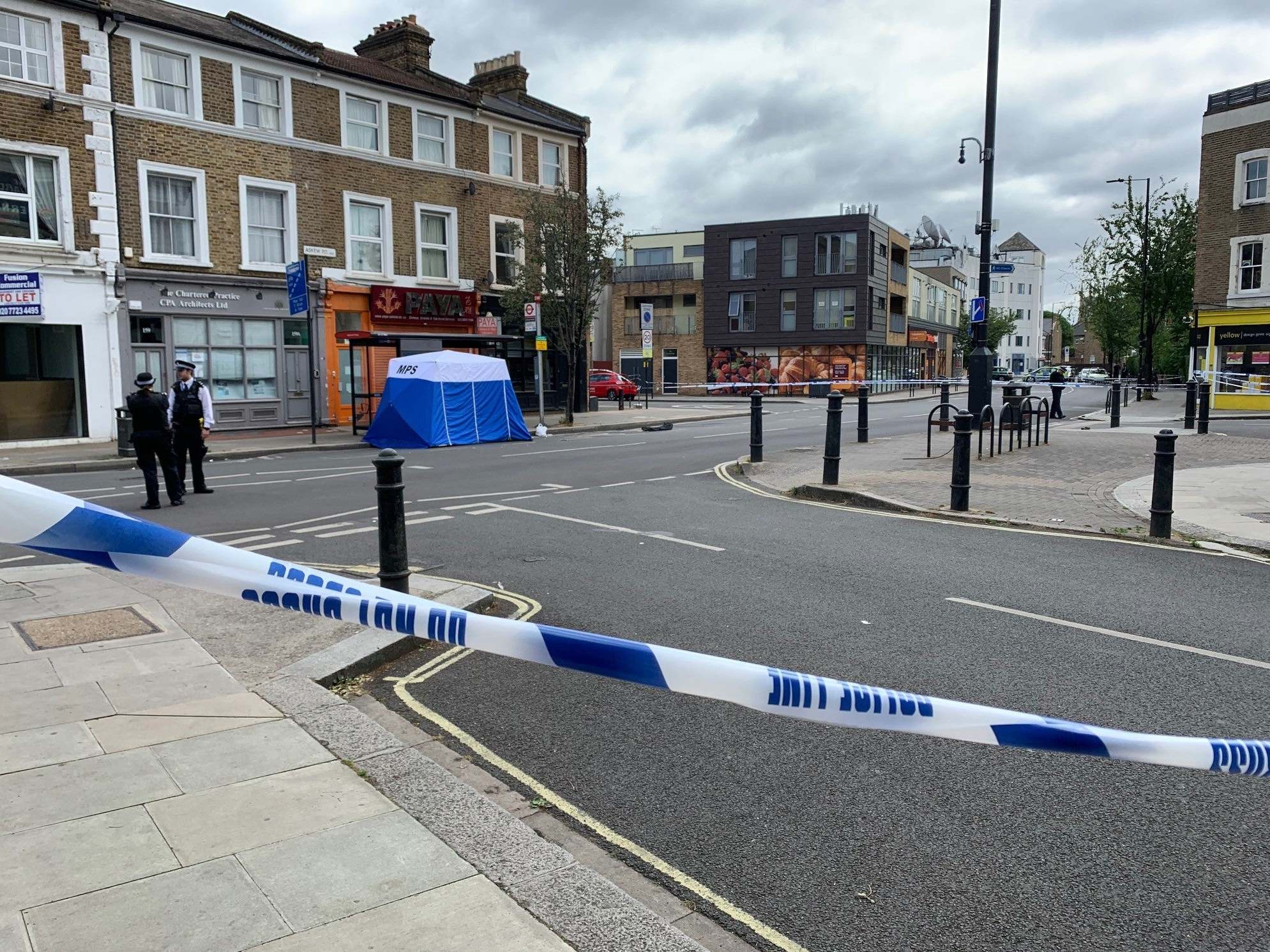 The scene at Askew Road, Shepherd's Bush, west London, after a man in his 20s was shot dead, 8 June 2020.