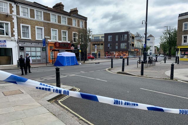 The scene at Askew Road, Shepherd's Bush, west London, after a man in his 20s was shot dead, 8 June 2020.