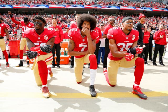 Colin Kaepernick kneels during the national anthem with fellow San Francisco 49ers Eli Harold and Eric Reid