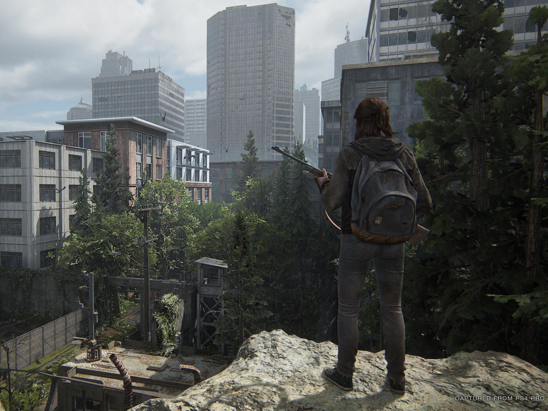 Ellie (Ashley Johnson) looks down at the overgrown streets of Seattle, where much of the game is set