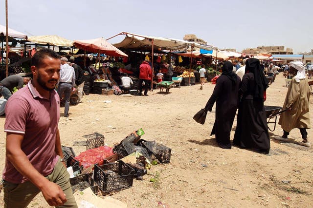 People shop at a vegetable market in the eastern Libyan port city of Benghazi
