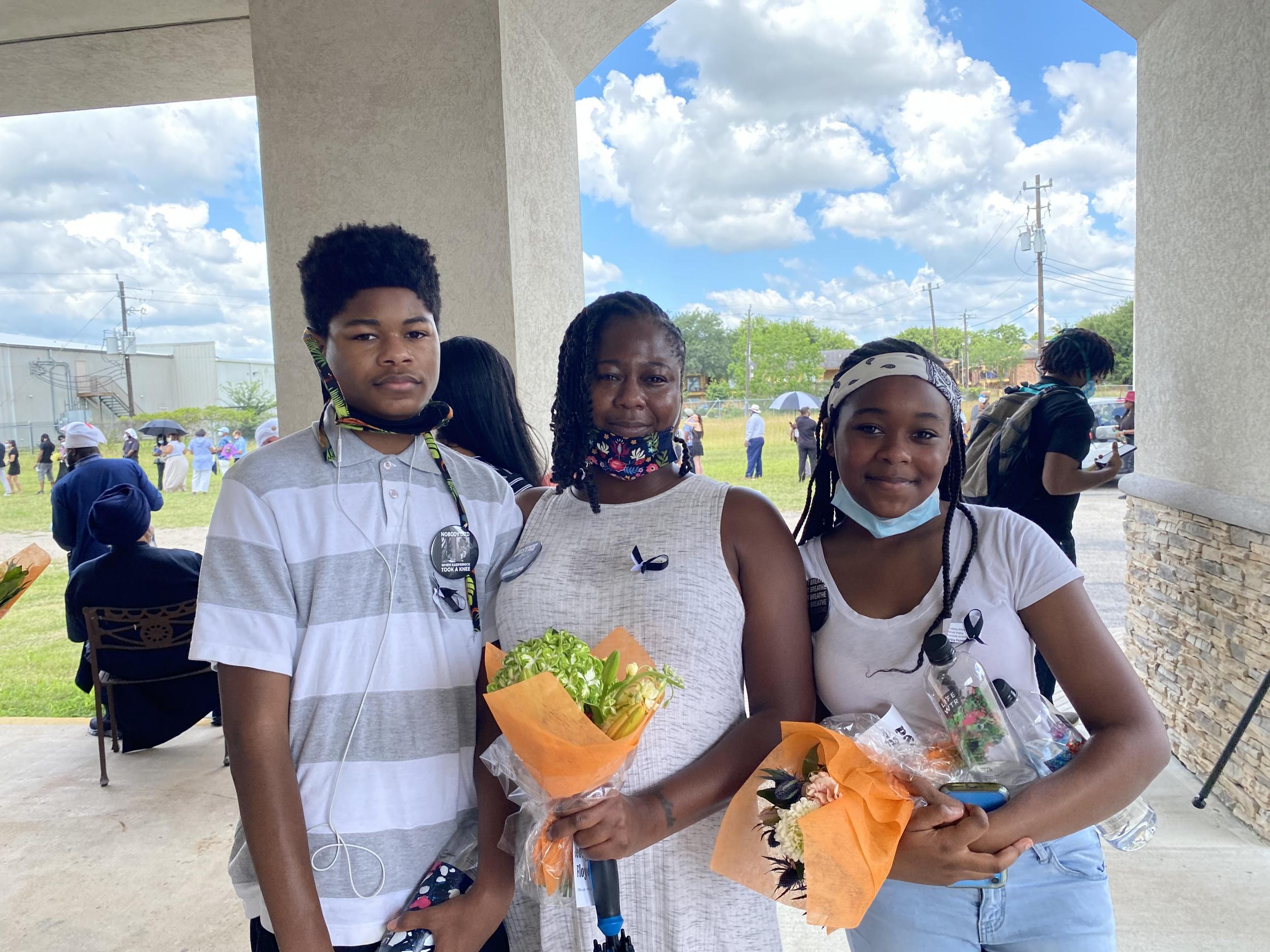 Ebony Randle, 41, with her two teenage children at the memorial service for George Floyd in Houston, Texas. (Richard Hall / The Independent )