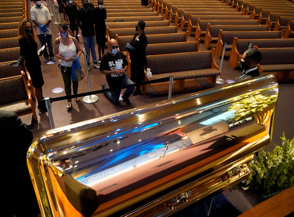 Mourners pass by the casket of George Floyd during a public visitation for Floyd at the Fountain of Praise church on June 8, 2020, in Houston,Texas