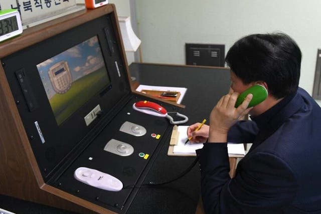 A South Korean official makes a test call with North Korea via a hotline set up at an inter-Korean liaison office in the truce village of Panmunjom, Joint Security Area, DMZ