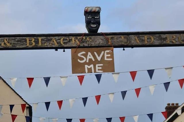 A sign saying 'Save Me' was hung from the controversial head in Derbyshire on Monday evening before it was taken down