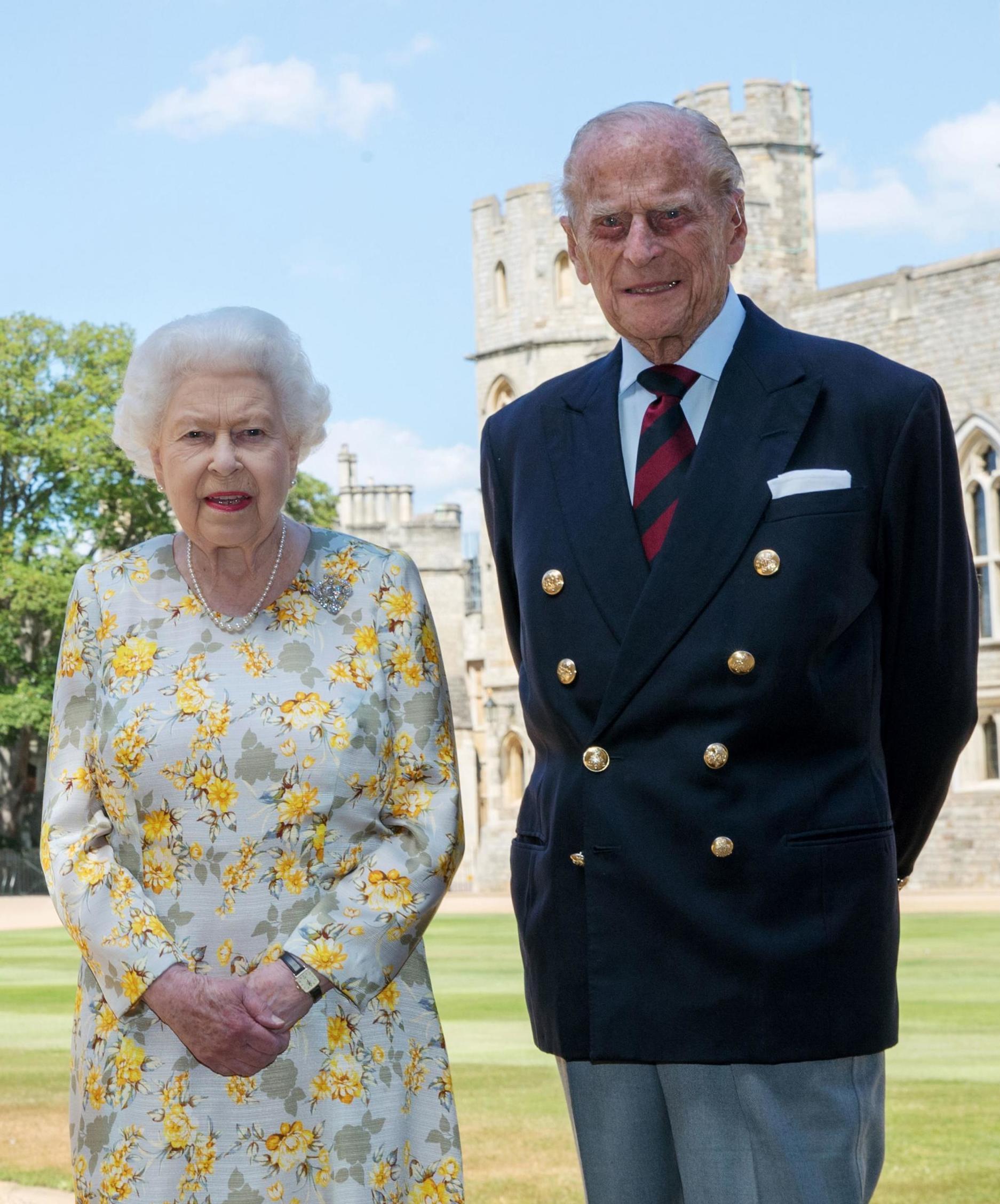 Queen Elizabeth II and the Duke of Edinburgh pose outside Windsor Castle ahead of his 99th birthday on 10 June 2020 (Steve Parsons/PA Wire)