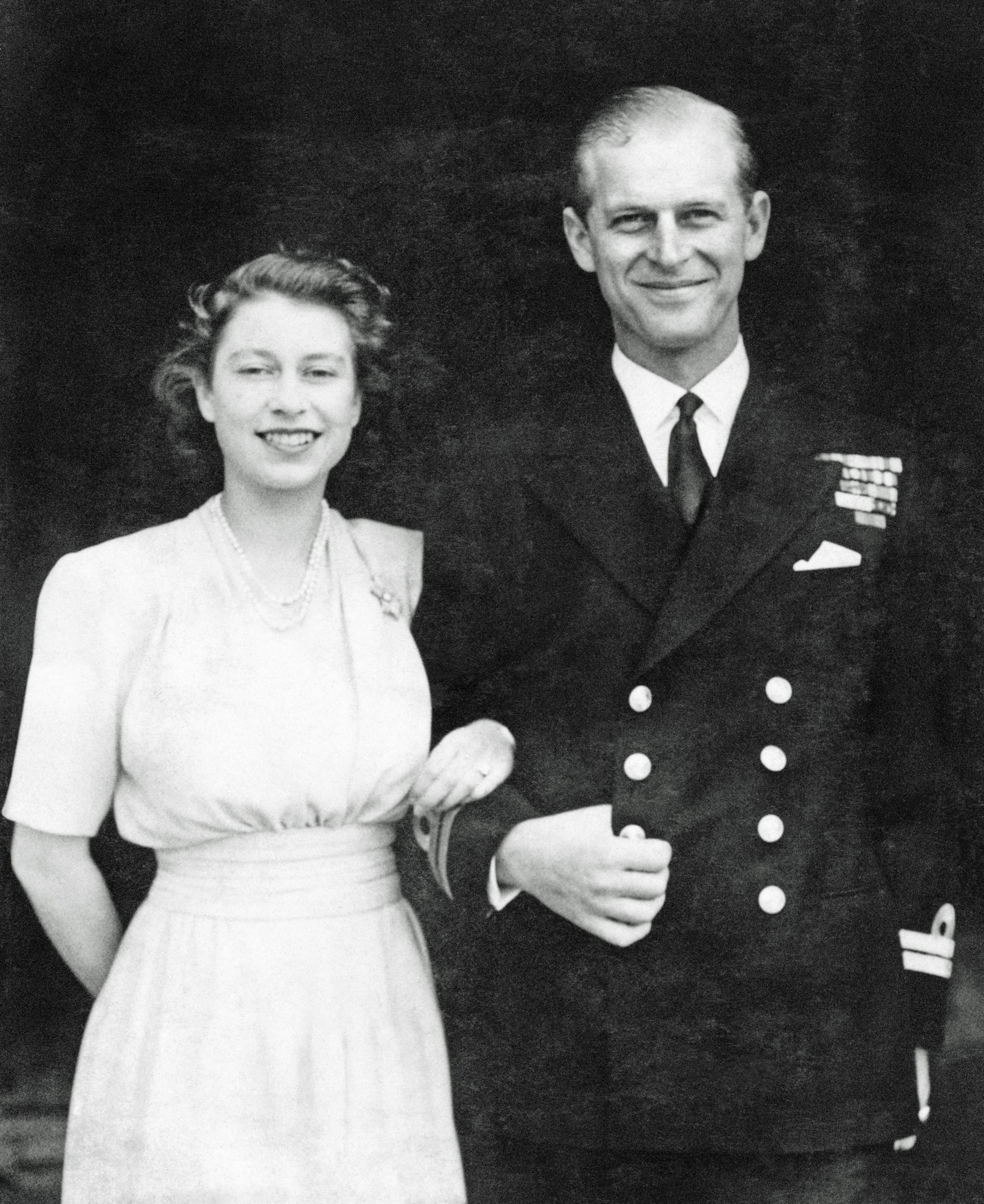 In 1947, the then Princess Elizabeth and Lieutenant Philip Mountbatten posed for engagement pictures at Buckingham Palace (PA)