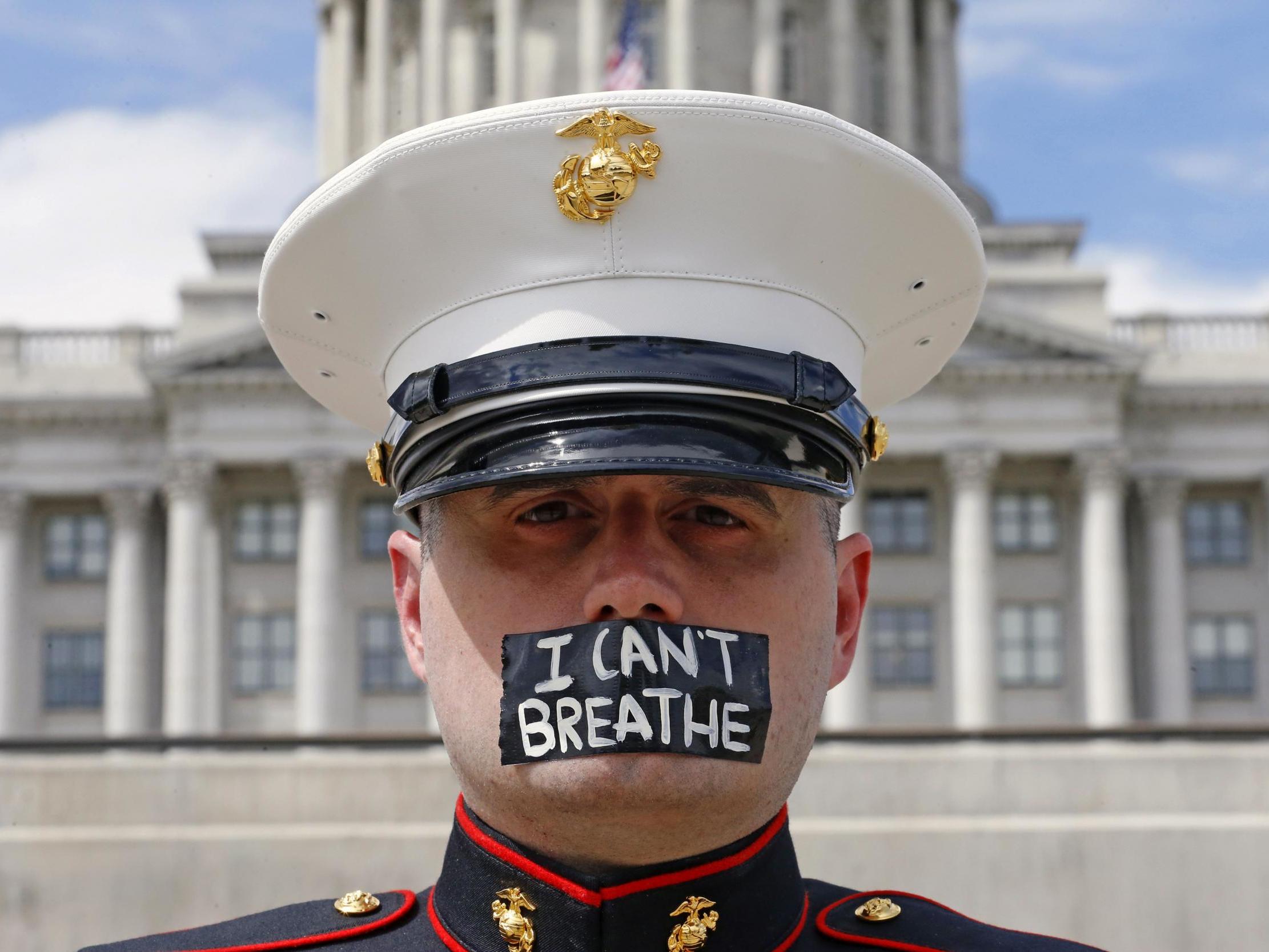Retired Marine Todd Winn, wearing a mask which reads "I Can't Breathe," participates in a protest in front of the Utah State Capitol in Salt Lake City