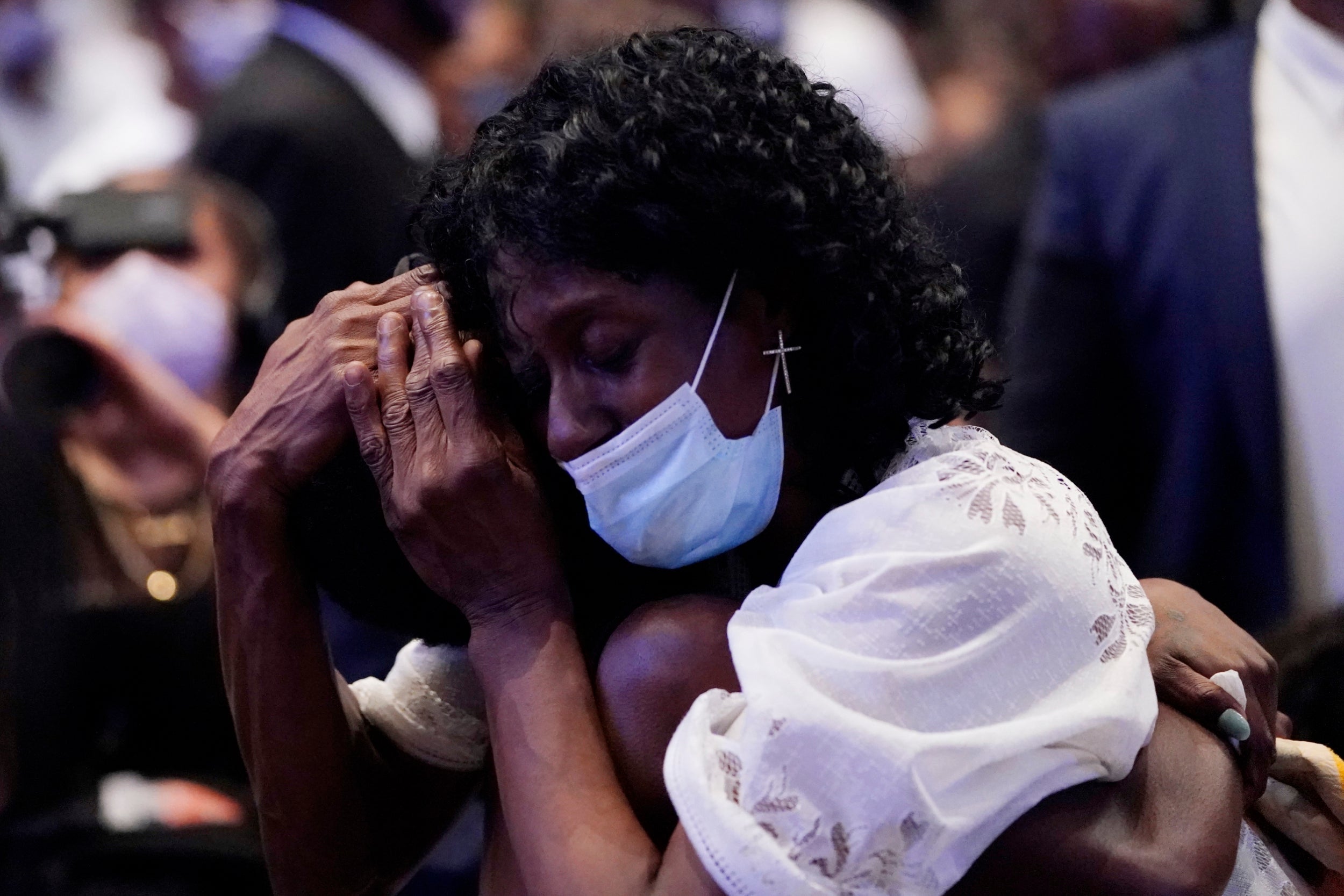 Zsa Zsa Floyd pauses near the casket of her brother George during a funeral service for him at The Fountain of Praise church in Houston, Texas