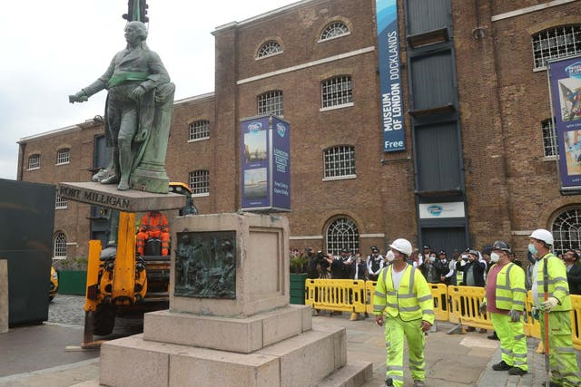 Workers take down a statue of slave owner Robert Milligan at West India Quay, east London
