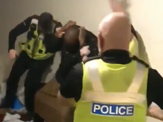 Police filmed hitting black man in head ‘used proportionate force’