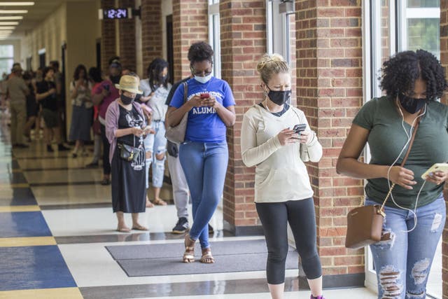 Voters wait in long lines at Peachcrest Elementary School in Decatur, Georgia, to vote in the state's primary election, Tuesday, 9 June, 2020.
