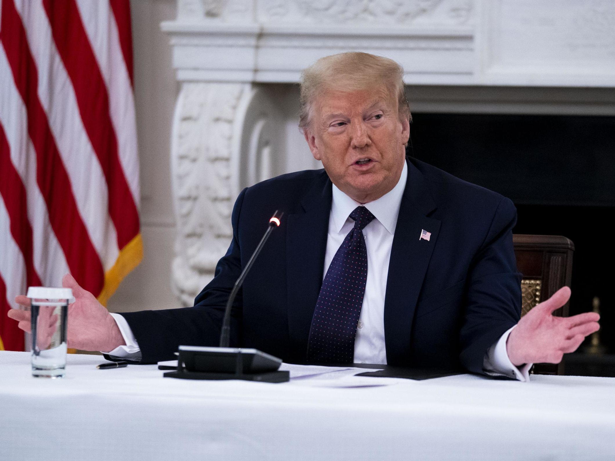 President Donald Trump makes remarks as he participates in a roundtable with law enforcement officials in the State Dining Room of the White House