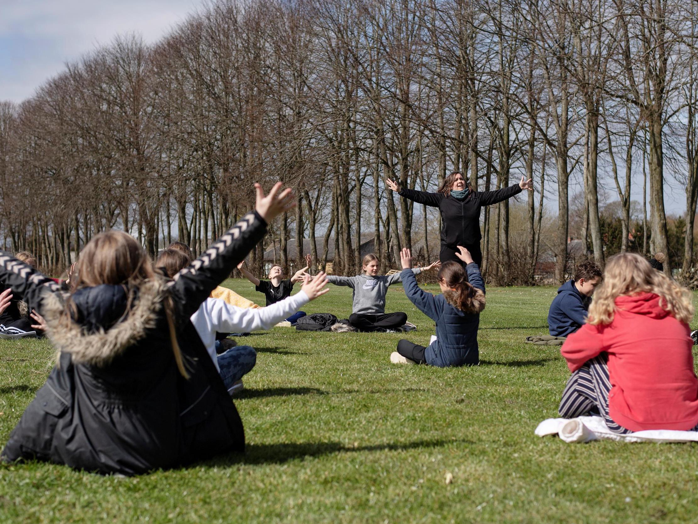 A music lesson is held outdoors at the Korshoejskolen school in Randers, Denmark