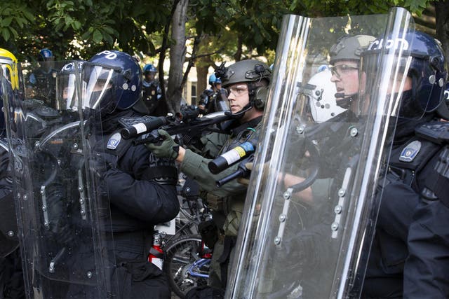 Police officers wearing riot gear shoot rubber bullets to demonstrators outside of the White House, June 1, 2020